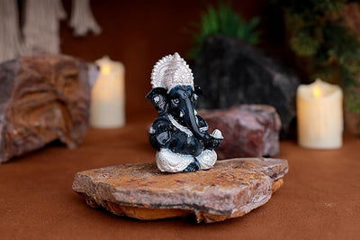 A silver-plated Lord Ganesha idol made of resin, intricately designed, measuring 5x5x5 cm, symbolizing wisdom and prosperity, perfect for decor.