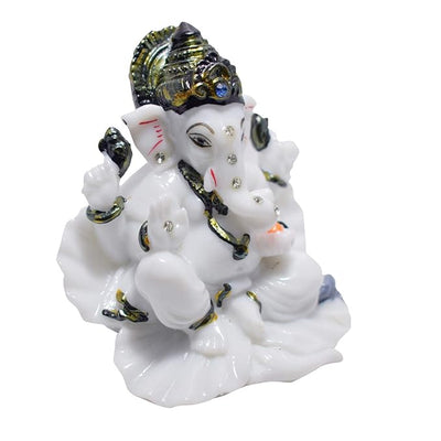 A beautifully crafted white marble idol of Lord Ganesha, symbolizing blessings and prosperity, suitable for car dashboards and home decor.