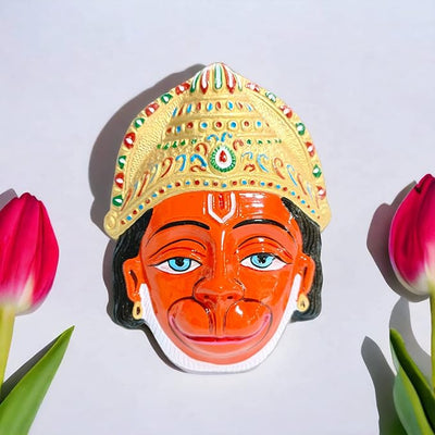 Handcrafted metal wall hanging of Lord Hanuman's face, featuring vibrant colors and intricate details, ideal for home decor and altars.