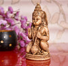 Handcrafted Lord Hanuman Ji idol made from synthetic material, featuring intricate carvings and a soothing beige color, ideal for spiritual spaces.