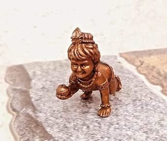 Handmade Lord Baby Krishna idol crafted from copper, featuring intricate detailing. Ideal for home altars and decor, symbolizing faith and spirituality.