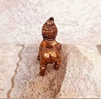 Handmade Lord Baby Krishna idol crafted from copper, featuring intricate detailing. Ideal for home altars and decor, symbolizing faith and spirituality