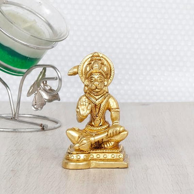 Handcrafted brass idol of Lord Hanumanji, featuring intricate details and a glossy gold finish, ideal for spiritual spaces and altars.