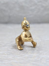 Brass Bal Gopal idol depicting Lord Krishna as a child, showcasing intricate details and a playful charm, ideal for enhancing spiritual spaces.