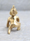 Brass Bal Gopal idol depicting Lord Krishna as a child, showcasing intricate details and a playful charm, ideal for enhancing spiritual spaces.