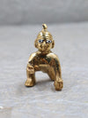 Brass Bal Gopal idol depicting Lord Krishna as a child, showcasing intricate details and a playful charm, ideal for enhancing spiritual spaces.