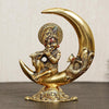 Handcrafted golden metal Lord Krishna idol, depicting him playing the flute on a half moon, showcasing intricate details and elegance.