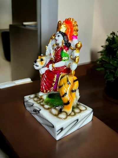 Handmade Maa Durga idol sculpture seated on a tiger, crafted from high-quality resin with vibrant colors, ideal for worship and home decor.