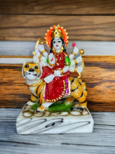 Handmade Maa Durga idol sculpture seated on a tiger, crafted from high-quality resin with vibrant colors, ideal for worship and home decor.