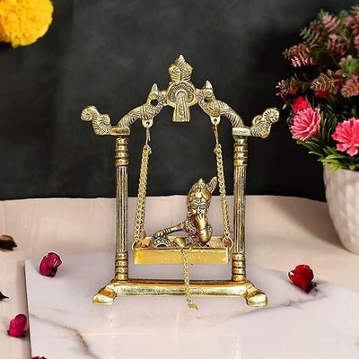 Handcrafted metal Krishna Jhula featuring child Krishna on a swing, measuring 13.5 x 19.5 x 6.5 cm. Ideal for home altar or decor.