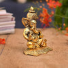 A small golden idol of Lord Ganesha, the Hindu god of wisdom and remover of obstacles, suitable for home decor.