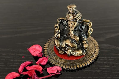 Intricately crafted metal Lord Ganesha statue on a round base, symbolizing wisdom and prosperity, perfect for home decor