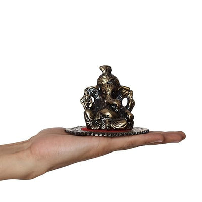 Intricately crafted metal Lord Ganesha statue on a round base, symbolizing wisdom and prosperity, perfect for home decor