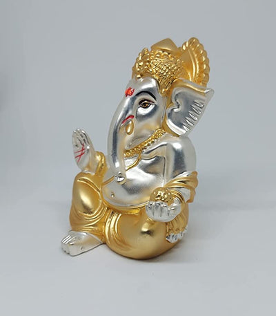 A beautifully handcrafted Lord Ganesha idol, featuring intricate details and a two-tone matte finish, perfect for home decor or car dashboards.