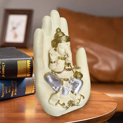 Handcrafted Palm Ganesha idol in polyresin, featuring a tranquil design perched on a palm, symbolizing wisdom and harmony for home decor.