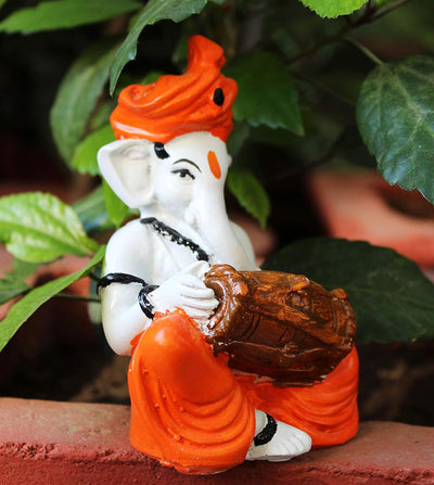 Handmade Playful Ganesha idol crafted from microfiber, measuring 11 x 10 x 25 cm, depicting Lord Ganesha playing the dholak