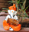 Handmade Playful Ganesha idol crafted from microfiber, measuring 11 x 10 x 25 cm, depicting Lord Ganesha playing the dholak