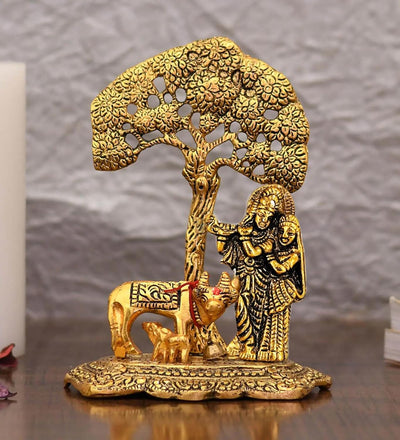 Handcrafted metal statue of Radha and Krishna under a Kadambh tree with a cow and calf, symbolizing divine love and traditional craftsmanship.