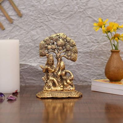 Handcrafted metal statue of Radha Krishna playing the flute, featuring a gold finish, symbolizing divine love and harmony.