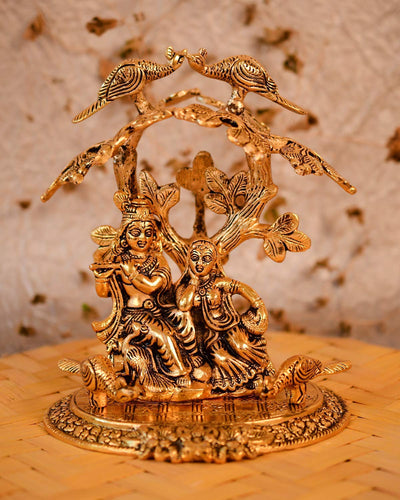 Handmade Radha Krishna statue featuring the divine couple playing the flute, crafted from metal with a gold finish, ideal for home or altar decor.