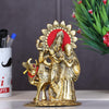 Handcrafted metal statue of Radha and Krishna in an embrace, accompanied by a serene cow, symbolizing divine love and traditional craftsmanship.
