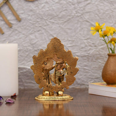 Handcrafted metal statue of Radha and Krishna playing the flute, measuring 11.4L x 5.1W x 17.8H cm, symbolizing love and devotion