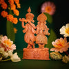 Handcrafted terracotta Radha Krishna idol in vibrant red and brown, depicting the divine couple playing the flute, ideal for home decor.