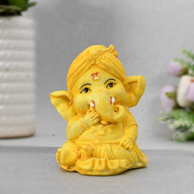 Handcrafted 300g resin Ganesha idol for car dashboard or home décor, featuring intricate details in a compact 3x3x2 cm size.