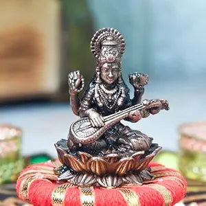 Handmade copper Saraswati idol, intricately designed, depicting the goddess of knowledge and arts with exquisite detailing.