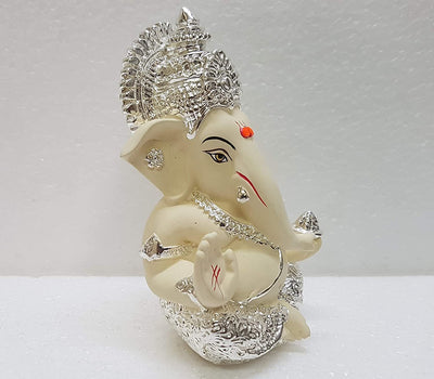 Handcrafted Silver Chandan Ganesha idol with intricate silver jewelry, symbolizing prosperity and wisdom, ideal for home decor and altars.