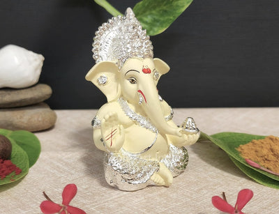 Handcrafted Silver Chandan Ganesha idol with intricate silver jewelry, symbolizing prosperity and wisdom, ideal for home decor and altars.