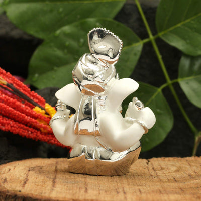 Handcrafted silver-plated Ganesha idol made of ceramic, symbolizing prosperity and blessings, ideal for home decor and altars.