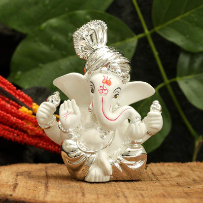 Handcrafted silver-plated Ganesha idol made of ceramic, symbolizing prosperity and blessings, ideal for home decor and altars.