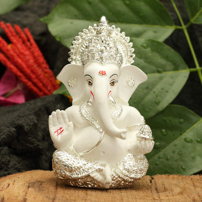 Handcrafted silver-plated Ganesha idol, symbolizing protection and good fortune, ideal for car interiors and altars.