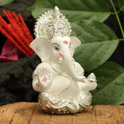 Handcrafted silver-plated Ganesha idol, symbolizing protection and good fortune, ideal for car interiors and altars.