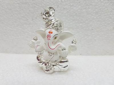 Handcrafted silver-plated Ganesha idol made of white terracotta, measuring 4L x 5W x 8.9H cm, perfect for home or car decor