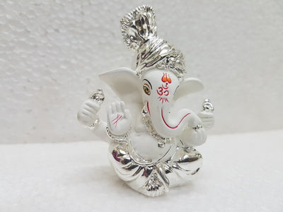 Handcrafted silver-plated Ganesha idol made of white terracotta, measuring 4L x 5W x 8.9H cm, perfect for home or car decor.