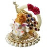 A small golden idol of Lord Ganesha, the Hindu god of wisdom and remover of obstacles, suitable for home decor.